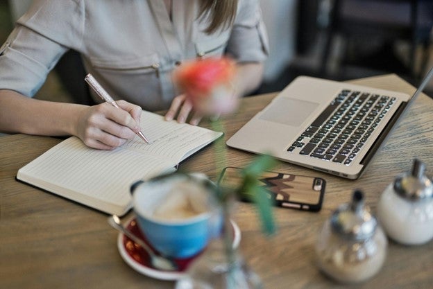 a woman writing in a book