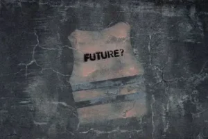 Torn paper on cracked surface with the word "FUTURE?"