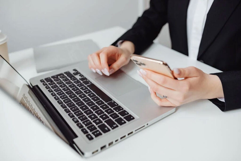 Women using laptop and phone