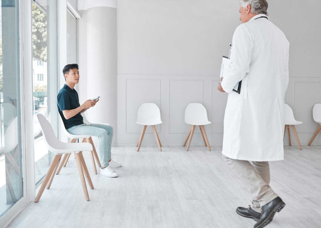 Patient sitting and doctor walking